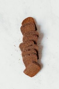 A freshly baked loaf of brown bread on a wooden table, highlighting its health benefits and nutrient-rich composition.